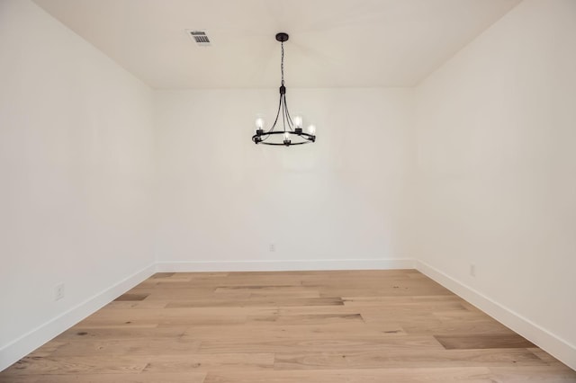 16090 Inca Dove Ct, Frisco, TX 75035 - unfurnished room with a chandelier, baseboards, and light wood finished floors
