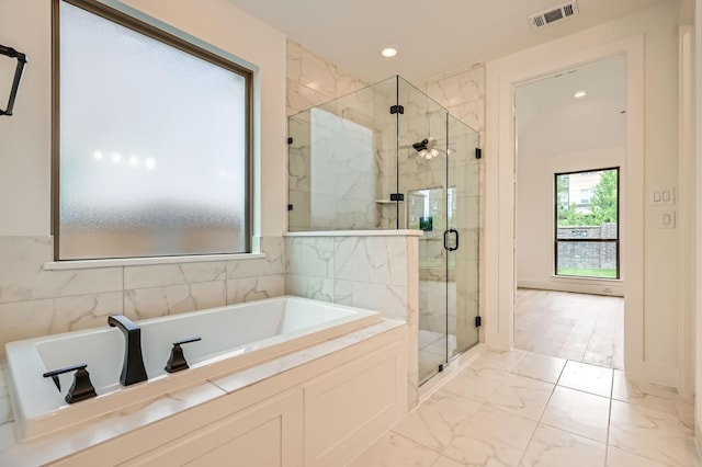 16090 Inca Dove Ct, Frisco, TX 75035 - bathroom featuring marble finish flooring, a marble finish shower, a garden tub, and recessed lighting