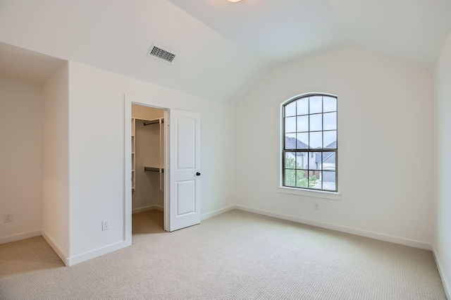 16090 Inca Dove Ct, Frisco, TX 75035 - unfurnished bedroom with light carpet, a spacious closet, baseboards, lofted ceiling, and a closet