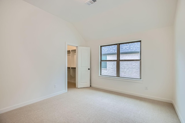 16090 Inca Dove Ct, Frisco, TX 75035 - unfurnished bedroom with light carpet, vaulted ceiling, a walk in closet, baseboards, and a closet