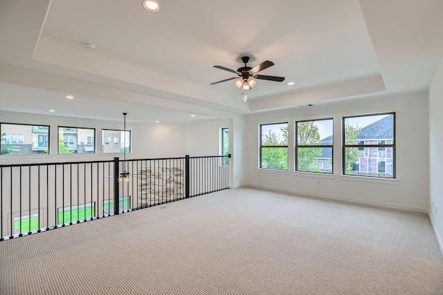 16090 Inca Dove Ct, Frisco, TX 75035 - spare room with a tray ceiling, light colored carpet, a ceiling fan, baseboards, and recessed lighting