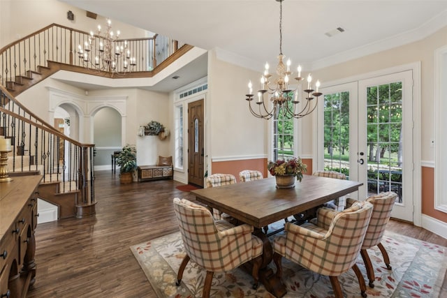 7307 Stallion Cir, Flower Mound, TX 75022 - dining space with crown molding, stairs, dark wood-style flooring, and a notable chandelier