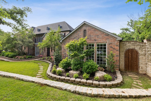 7307 Stallion Cir, Flower Mound, TX 75022 - view of property exterior featuring brick siding and a yard