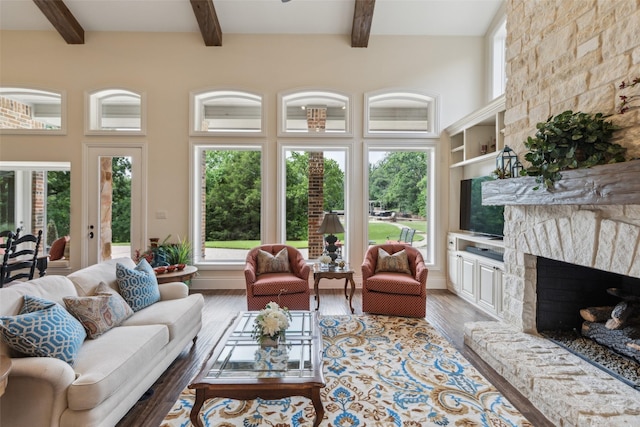 7307 Stallion Cir, Flower Mound, TX 75022 - living area featuring a fireplace, beamed ceiling, and light wood-type flooring
