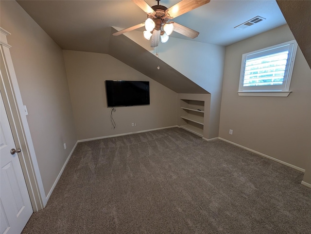 additional living space with lofted ceiling, visible vents, baseboards, carpet floors, and a ceiling fan