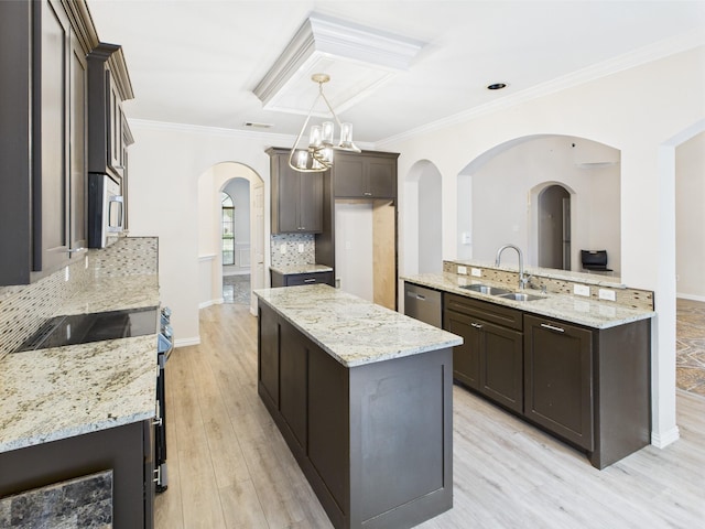 1264 Carriage Creek Dr, Desoto, TX 75115 - kitchen with a sink, a center island, decorative backsplash, arched walkways, and appliances with stainless steel finishes