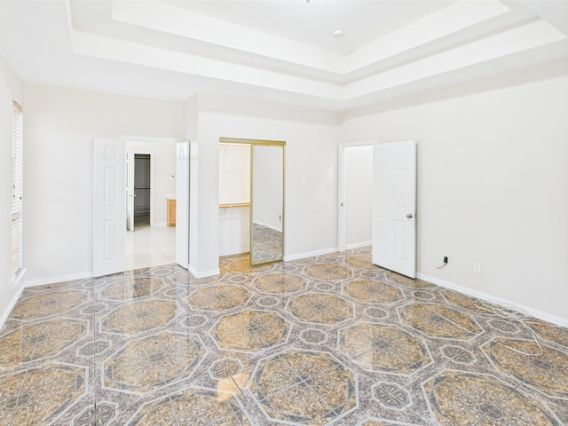 1264 Carriage Creek Dr, Desoto, TX 75115 - unfurnished bedroom featuring a tray ceiling, a closet, and baseboards