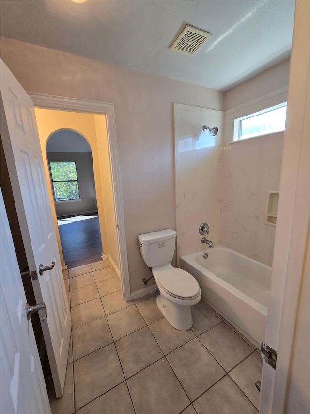 1264 Carriage Creek Dr, Desoto, TX 75115 - bathroom featuring toilet, healthy amount of natural light, tile patterned floors, and washtub / shower combination