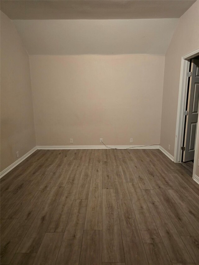 1264 Carriage Creek Dr, Desoto, TX 75115 - spare room with vaulted ceiling, dark wood finished floors, and baseboards