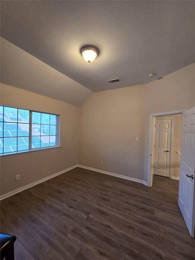 1264 Carriage Creek Dr, Desoto, TX 75115 - unfurnished room featuring dark wood finished floors, vaulted ceiling, a textured ceiling, and baseboards