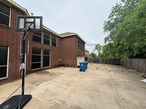 1264 Carriage Creek Dr, Desoto, TX 75115 - view of patio with an attached garage and fence