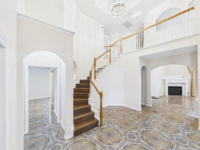 1264 Carriage Creek Dr, Desoto, TX 75115 - stairs featuring a towering ceiling, arched walkways, and a fireplace
