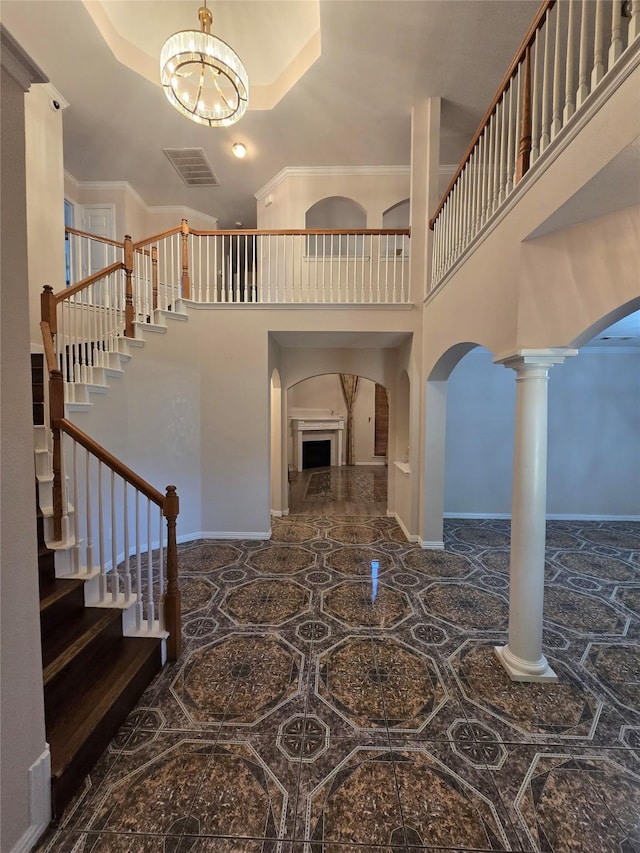 1264 Carriage Creek Dr, Desoto, TX 75115 - foyer entrance with arched walkways, a high ceiling, a chandelier, stairway, and baseboards
