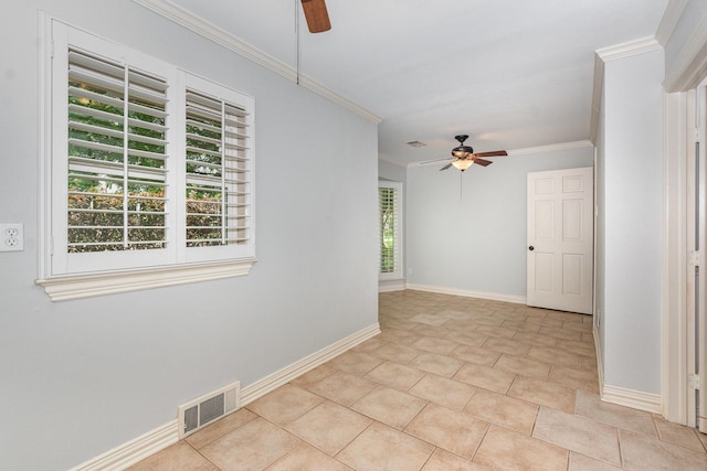 empty room featuring plenty of natural light, a ceiling fan, and visible vents