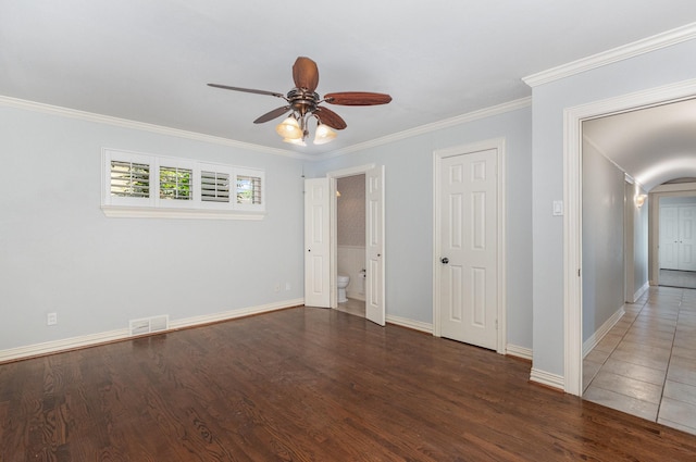 unfurnished bedroom with baseboards, visible vents, ornamental molding, and wood finished floors