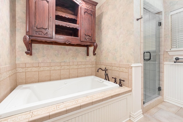 bathroom with tile patterned flooring, a bath, and a stall shower