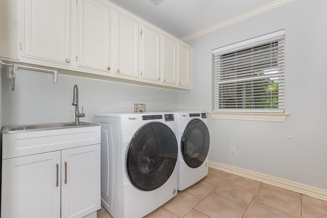 laundry room with ornamental molding, baseboards, washer and clothes dryer, a sink, and cabinet space