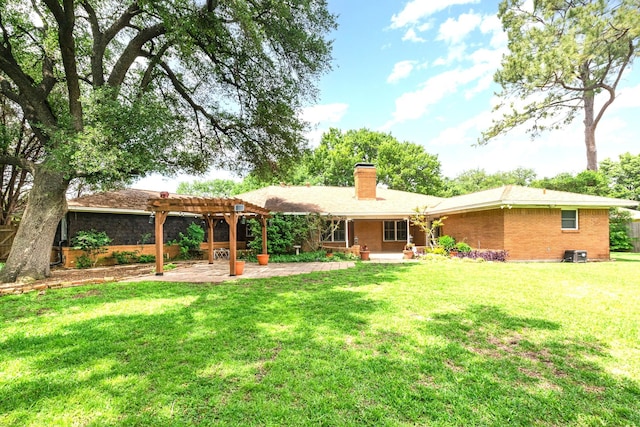 rear view of property with a chimney, a lawn, brick siding, a patio, and a pergola