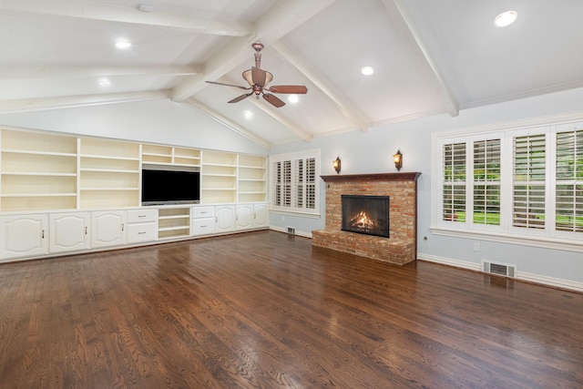 unfurnished living room with dark wood-style flooring, a brick fireplace, a ceiling fan, vaulted ceiling with beams, and visible vents