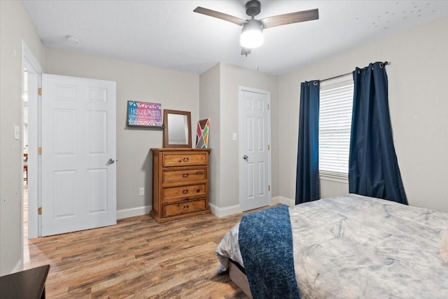 bedroom with baseboards, wood finished floors, and a ceiling fan
