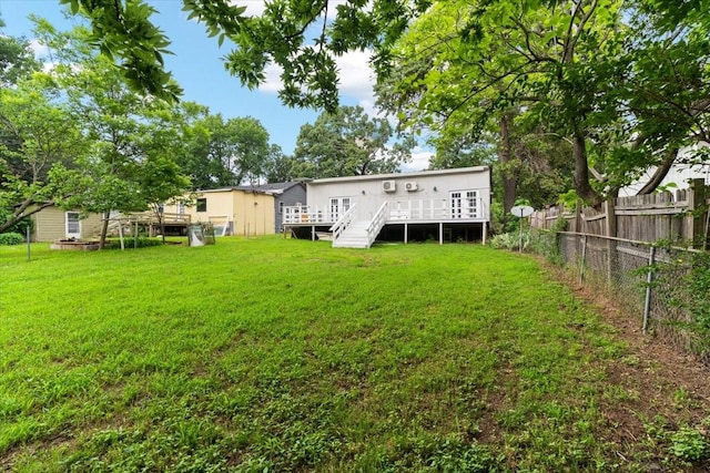rear view of house featuring a deck, fence private yard, and a yard
