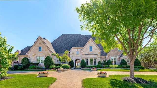 5409 Twin Cities Ln, Mckinney, TX 75070 - french country home with stone siding and a front yard