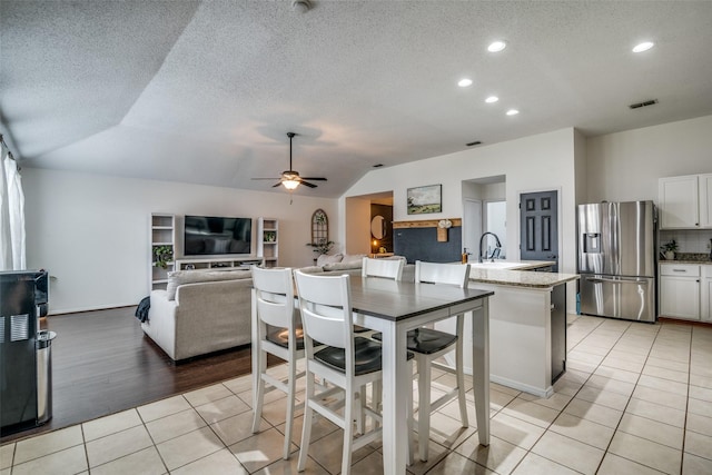 dining space with visible vents, lofted ceiling, recessed lighting, a ceiling fan, and light tile patterned floors
