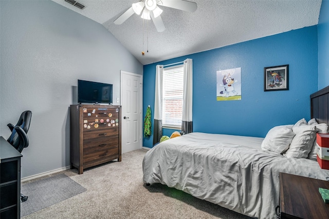 carpeted bedroom featuring a textured ceiling, vaulted ceiling, ceiling fan, and visible vents