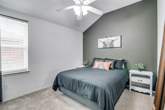 carpeted bedroom featuring a ceiling fan, baseboards, and lofted ceiling