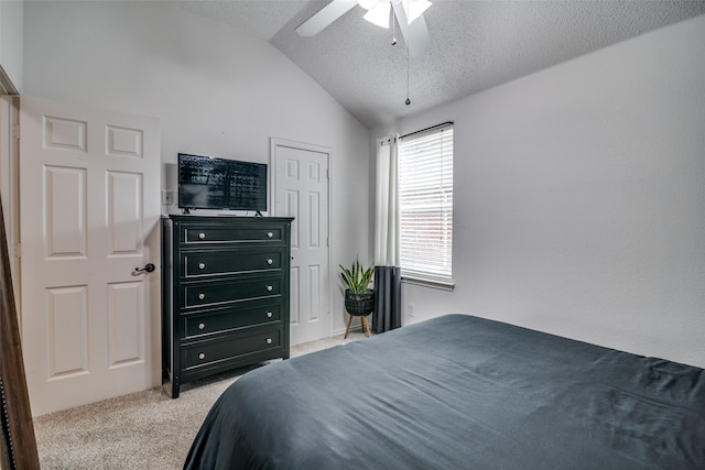 bedroom featuring a textured ceiling, carpet, ceiling fan, and vaulted ceiling