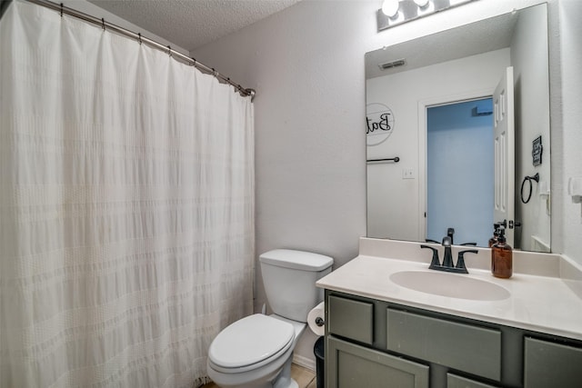 bathroom with visible vents, a textured ceiling, toilet, and vanity