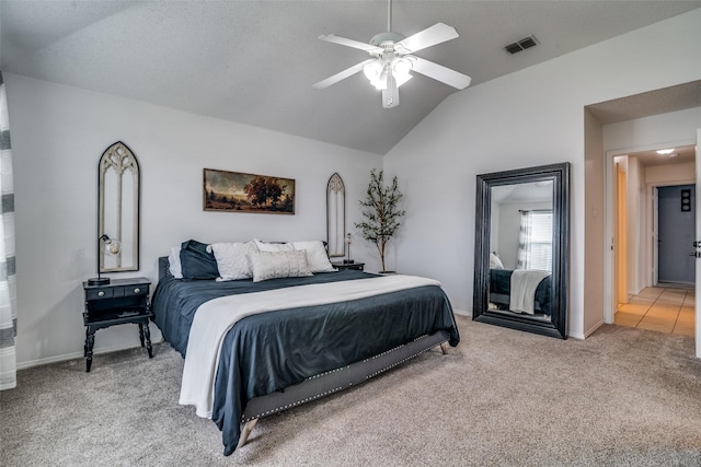 bedroom featuring visible vents, light carpet, baseboards, ceiling fan, and vaulted ceiling