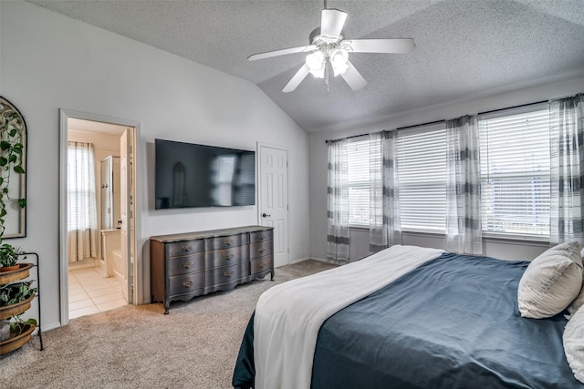 bedroom with carpet floors, vaulted ceiling, and multiple windows