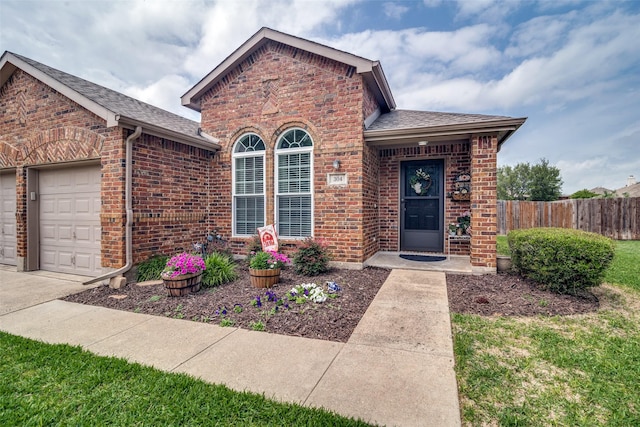 view of front of home featuring fence, a garage, roof with shingles, and brick siding