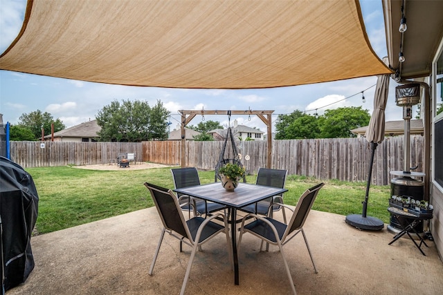 view of patio with outdoor dining space and a fenced backyard