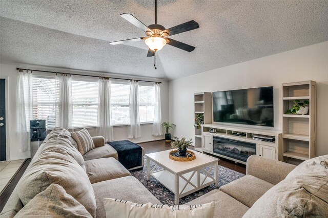 living room featuring a textured ceiling, ceiling fan, and wood finished floors