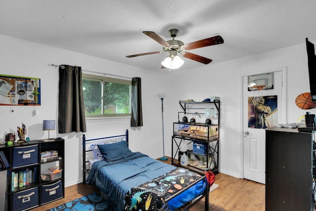 608 Timothy Dr, Fort Worth, TX 76028 - bedroom featuring baseboards, wood finished floors, a ceiling fan, and a textured ceiling