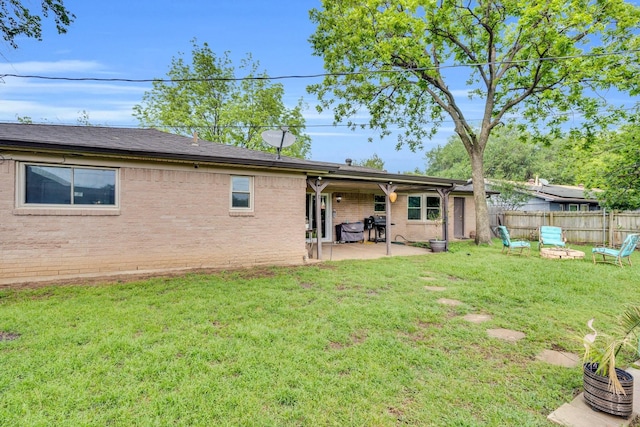 608 Timothy Dr, Fort Worth, TX 76028 - back of property with fence, a yard, a patio, and brick siding