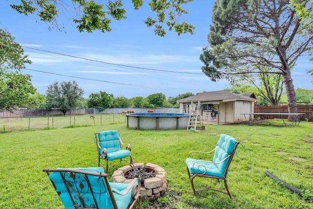 608 Timothy Dr, Fort Worth, TX 76028 - view of yard featuring an outdoor fire pit, an outbuilding, a fenced in pool, a fenced backyard, and a shed