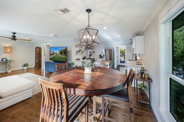 dining area featuring recessed lighting, ornamental molding, ceiling fan with notable chandelier, and visible vents