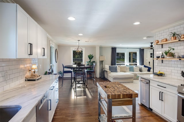 607 Parker St, Mckinney, TX 75069 - kitchen with decorative backsplash, open shelves, white cabinets, ornamental molding, and light stone counters