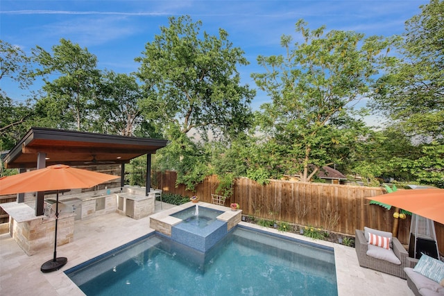 view of swimming pool featuring a patio, a fenced backyard, an outdoor kitchen, a fenced in pool, and an in ground hot tub