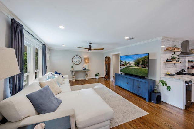 living room with visible vents, ornamental molding, wood finished floors, ceiling fan, and recessed lighting