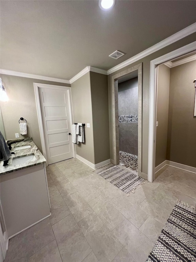 bathroom featuring a walk in shower, ornamental molding, vanity, baseboards, and visible vents