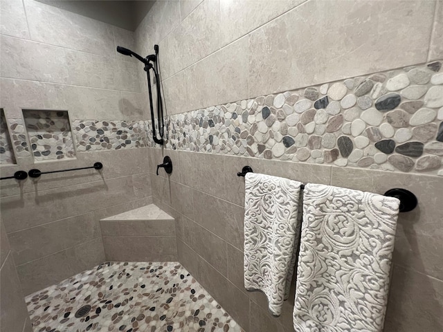 bathroom with a tile shower