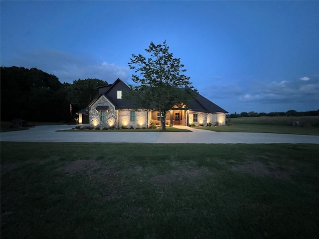 view of front of home featuring a front yard and stone siding