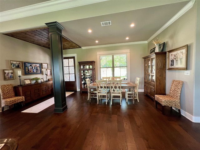 dining area featuring baseboards, visible vents, wood finished floors, and decorative columns