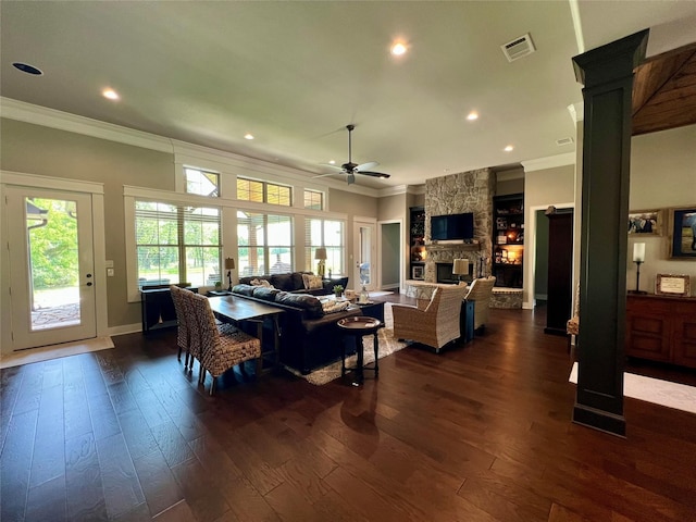 living room with dark wood finished floors, visible vents, ornamental molding, and ceiling fan