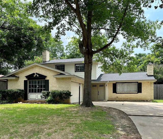 2804 Hollywood Dr, Arlington, TX 76013 - view of front of house featuring a front yard, driveway, a chimney, and brick siding