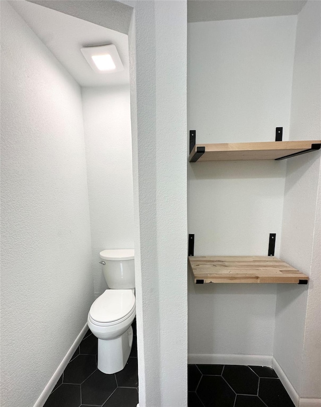 2804 Hollywood Dr, Arlington, TX 76013 - bathroom with toilet, tile patterned flooring, and baseboards